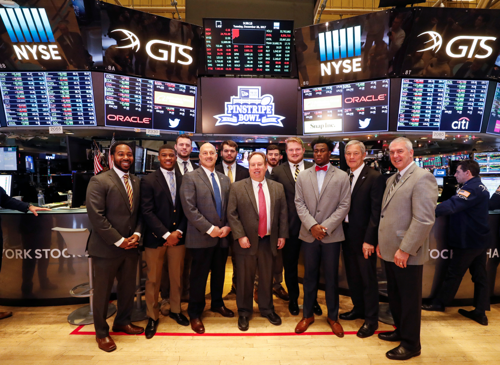 Iowa Hawkeyes linebacker Josey Jewell (43), defensive back Joshua Jackson (15), offensive lineman Sean Welsh (79) and head coach Kirk Ferentz ring the opening bell at the New York Stock Exchange Tuesday, December 26, 2017 in New York. (Brian Ray/hawkeyesports.com)
