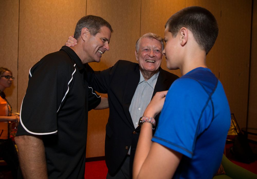Former Hawkeye Football Head Coach Hayden Fry talks with former quarterback Mark Vlasic and his son before a panel discussion during Fry Fest Friday, Aug. 29, 2014 in Coralville. (Brian Ray/hawkeyesports.com)