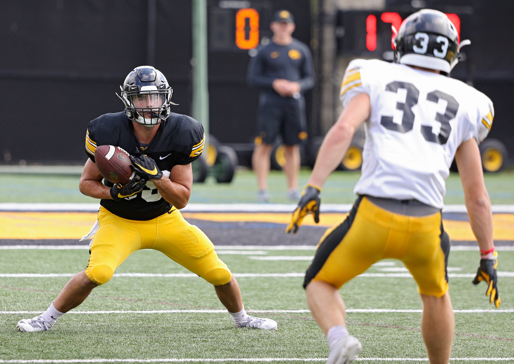 Iowa Hawkeyes wide receiver Nico Ragaini (89) pulls in a punt as defensive back Riley Moss (33) closes in during Fall Camp Practice No. 11 at the Hansen Football Performance Center in Iowa City on Wednesday, Aug 14, 2019. (Stephen Mally/hawkeyesports.com)
