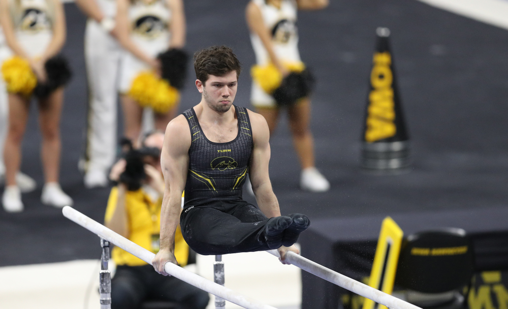 Iowa's Rogelio Vazquez competes on the parallel bars against Oklahoma Saturday, February 9, 2019 at Carver-Hawkeye Arena. (Brian Ray/hawkeyesports.com)