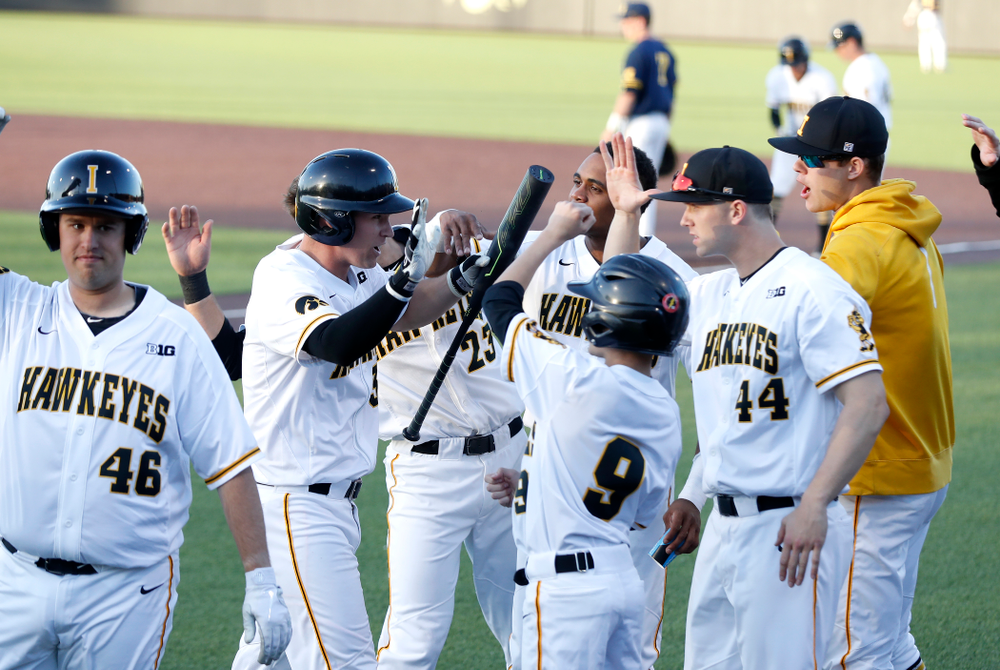 Iowa Hawkeyes infielder Matt Hoeg (3) celebrates with his teammates after scoring against the Michigan Wolverines Friday, April 27, 2018 at Duane Banks Field in Iowa City. (Brian Ray/hawkeyesports.com)