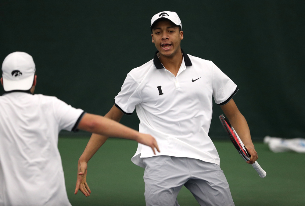 Iowa's Will Davies and Oliver Okonkwo celebrate after winning a doubles match against Western Michigan Saturday, January 19, 2019 at the Hawkeye Tennis and Recreation Complex. (Brian Ray/hawkeyesports.com)