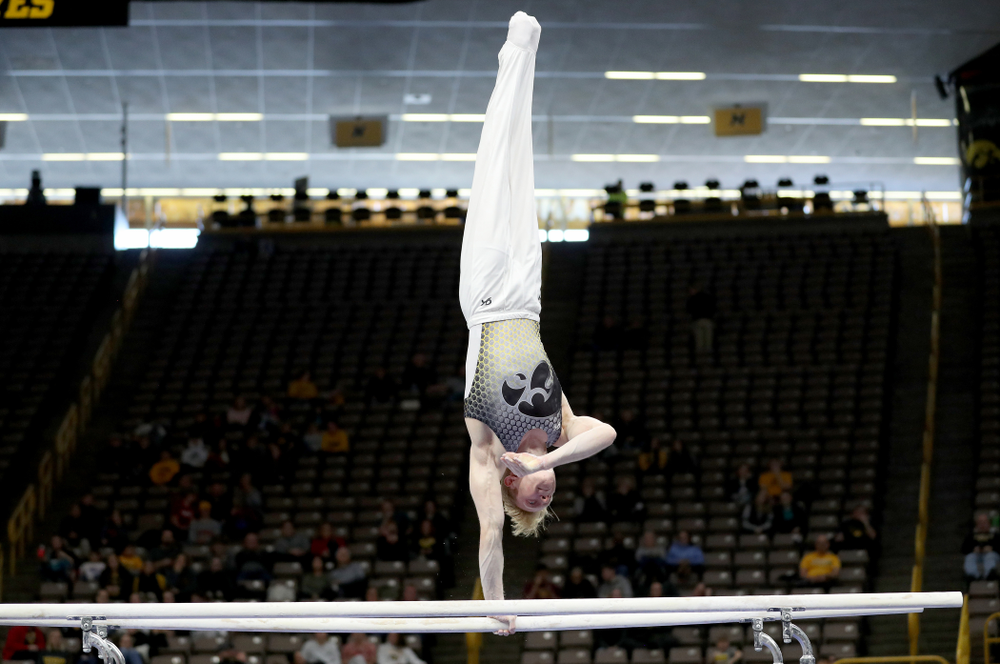 Iowa’s Nick Merryman competes on the parallel bars against UIC and Minnesota Saturday, February 1, 2020 at Carver-Hawkeye Arena. (Brian Ray/hawkeyesports.com)