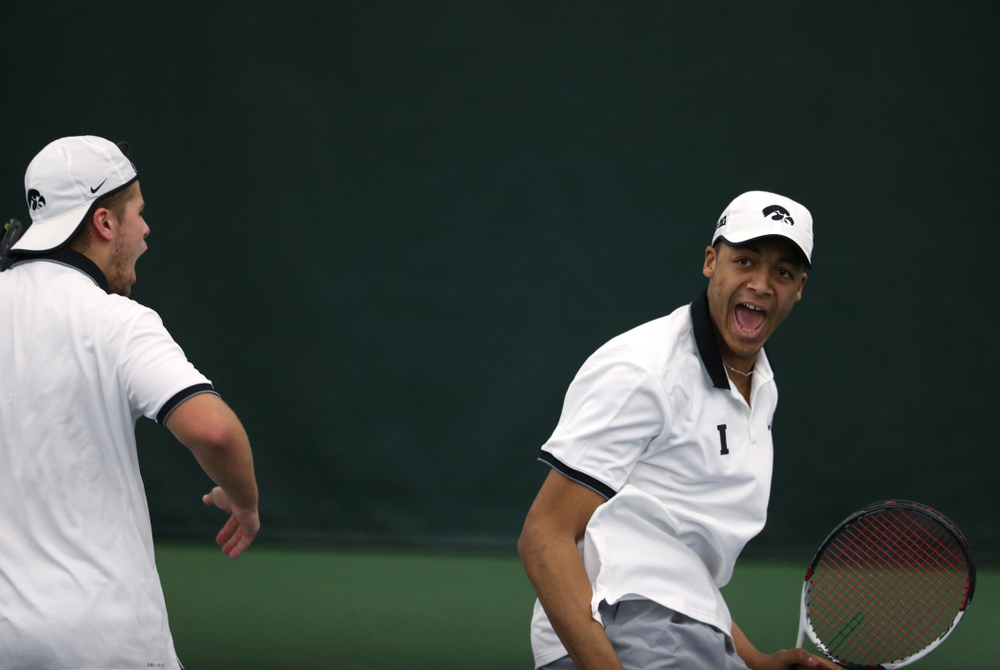 Iowa's Will Davies and Oliver Okonkwo celebrate after winning a doubles match against Western Michigan Saturday, January 19, 2019 at the Hawkeye Tennis and Recreation Complex. (Brian Ray/hawkeyesports.com)