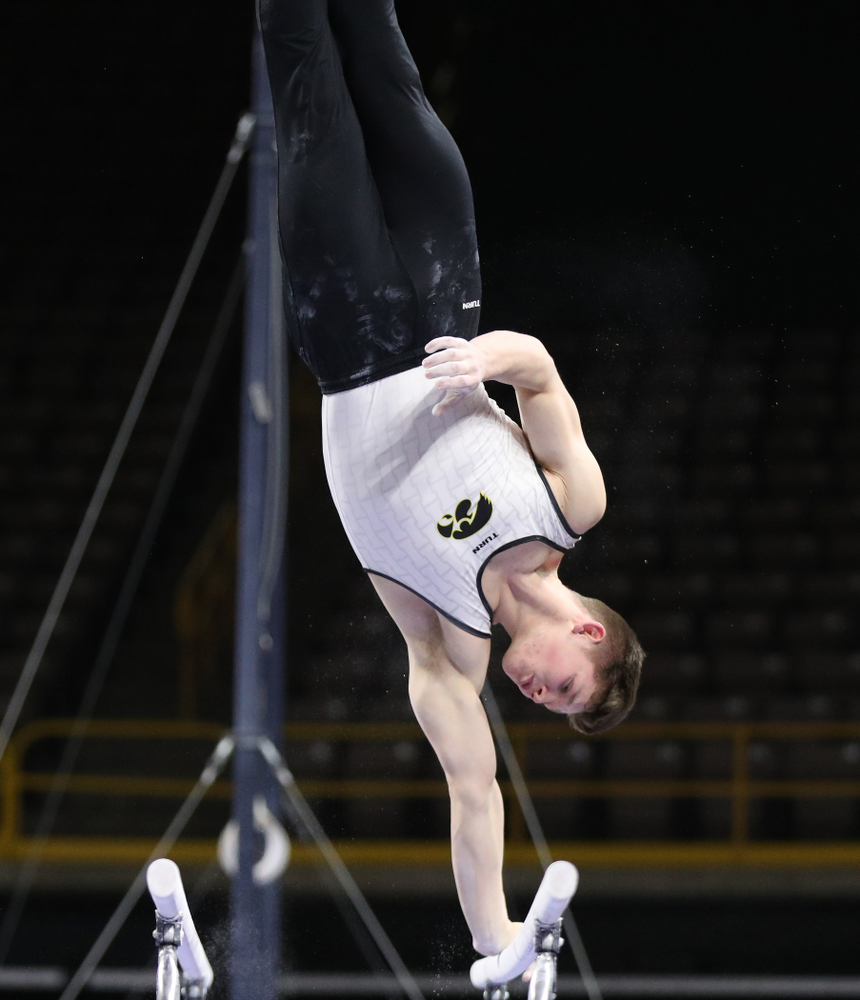 Iowa's Stewart Brown competes on the parallel bars against UIC and Minnesota Saturday, February 2, 2019 at Carver-Hawkeye Arena. (Brian Ray/hawkeyesports.com)