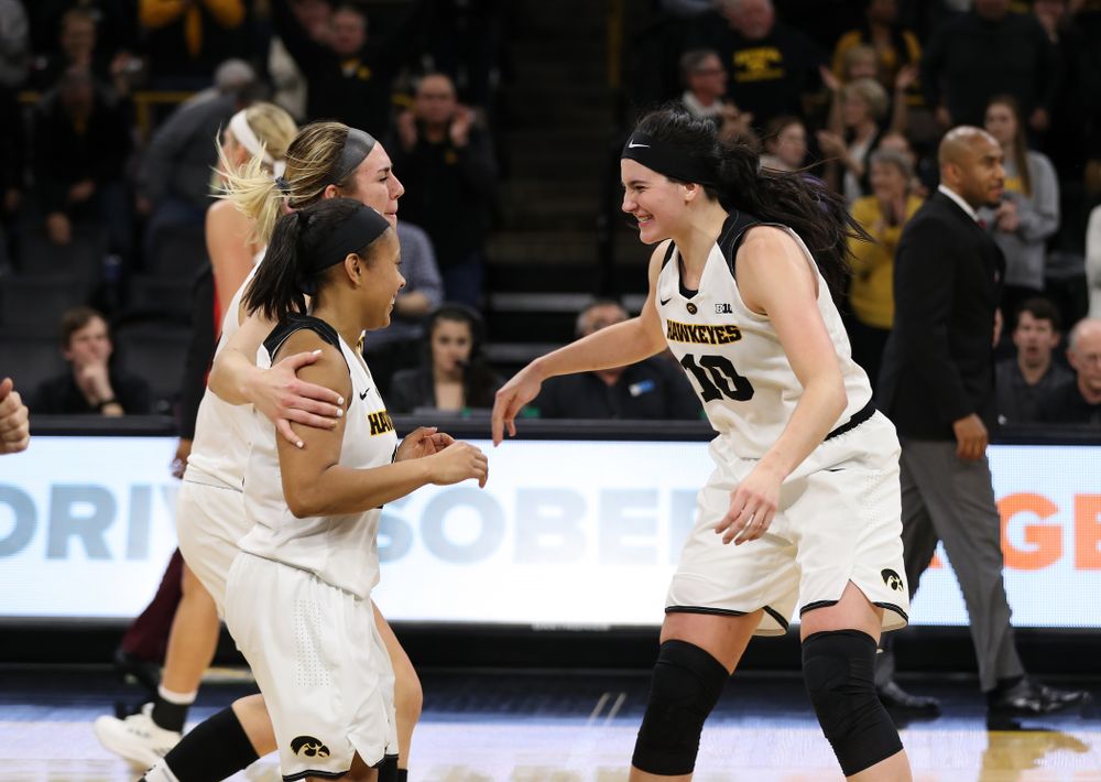 Iowa Hawkeyes forward Megan Gustafson (10), forward Hannah Stewart (21), and guard Tania Davis (11) celebrate their victory against the Nebraska Cornhuskers Thursday, January 3, 2019 at Carver-Hawkeye Arena. (Brian Ray/hawkeyesports.com)