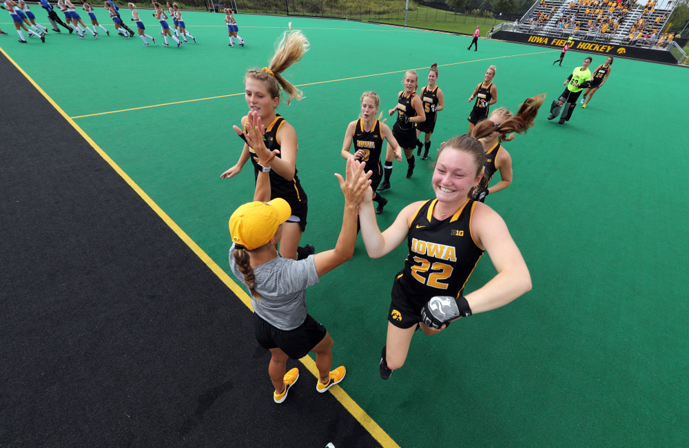 Iowa Hawkeyes Ellie Holley (7) and defenseman Ellie Flynn (22) slap hands with assistant coach Roz Ellis before their game against the Duke Blue Devils Sunday, September 15, 2019 at Grant Field. (Brian Ray/hawkeyesports.com)