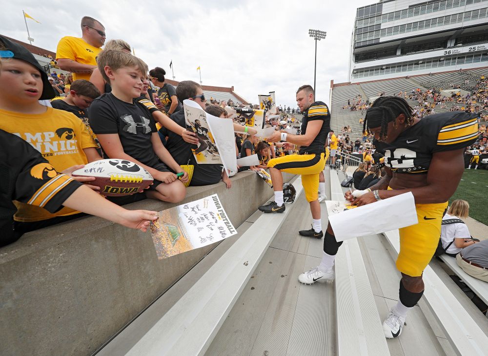 Iowa Hawkeyes wide receiver Brandon Smith (12) signs an autograph during Kids Day at Kinnick Stadium in Iowa City on Saturday, Aug 10, 2019. (Stephen Mally/hawkeyesports.com)