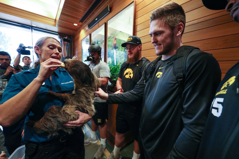 Iowa Hawkeyes offensive lineman Landan Paulsen (68), offensive lineman Levi Paulsen (66), linebacker Nick Niemann (49), and defensive lineman Cedrick Lattimore (95) check out a two toed sloth during a trip to the San Diego Zoo Wednesday, December 25, 2019 in San Diego. (Brian Ray/hawkeyesports.com)