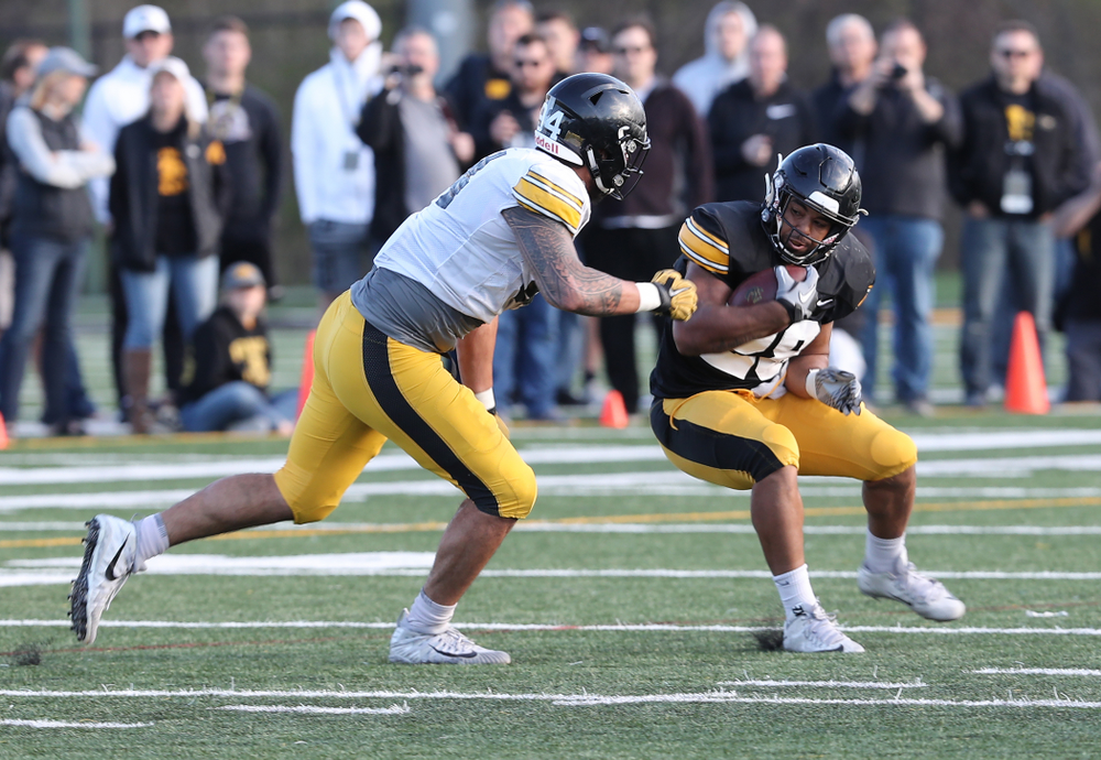 Iowa Hawkeyes running back Toren Young (28) and defensive end A.J. Epenesa (94) during the teamÕs final spring practice Friday, April 26, 2019 at the Kenyon Football Practice Facility. (Brian Ray/hawkeyesports.com)