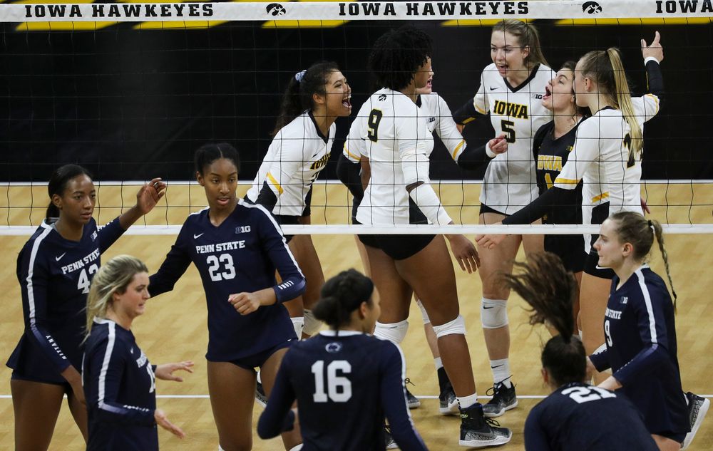 Iowa Hawkeyes setter Brie Orr (7), Iowa Hawkeyes outside hitter Meghan Buzzerio (5) and Iowa Hawkeyes defensive specialist Molly Kelly (1) celebrate after winning a point during a match against Penn State at Carver-Hawkeye Arena on November 3, 2018. (Tork Mason/hawkeyesports.com)