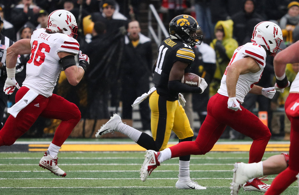 Iowa Hawkeyes defensive back Michael Ojemudia (11) returns an interception during a game against Nebraska at Kinnick Stadium on November 23, 2018. (Tork Mason/hawkeyesports.com)