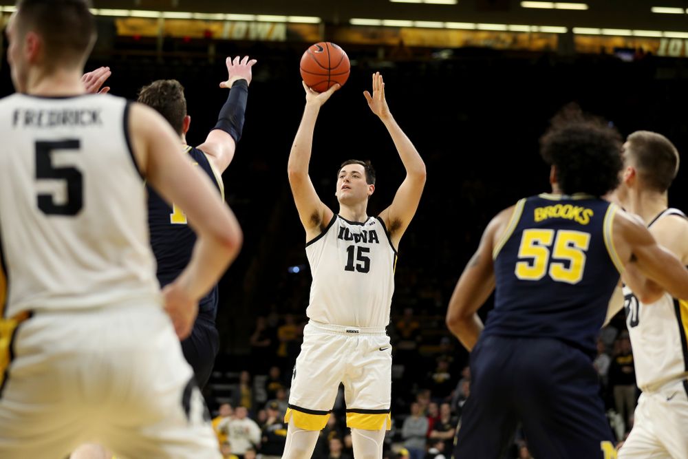 Iowa Hawkeyes forward Ryan Kriener (15) knocks down a shot against the Michigan Wolverines Friday, January 17, 2020 at Carver-Hawkeye Arena. (Brian Ray/hawkeyesports.com)