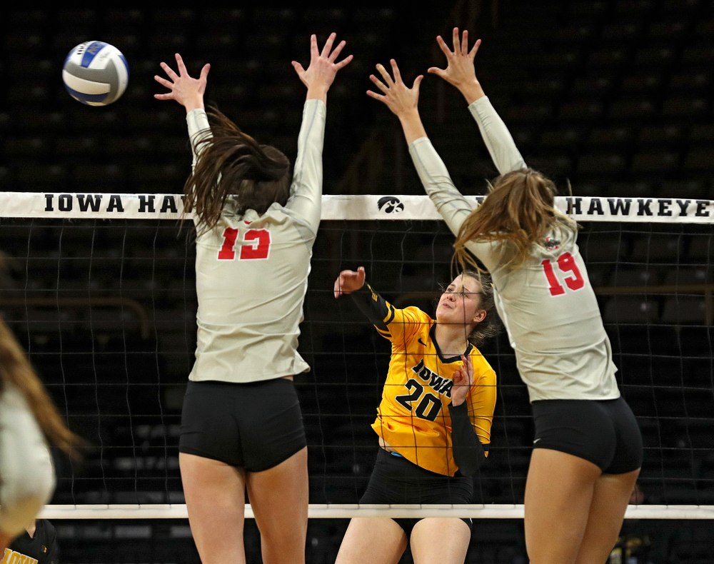 Iowa’s Edina Schmidt (20) gets a kill shot over during the first set of their match at Carver-Hawkeye Arena in Iowa City on Friday, Nov 29, 2019. (Stephen Mally/hawkeyesports.com)