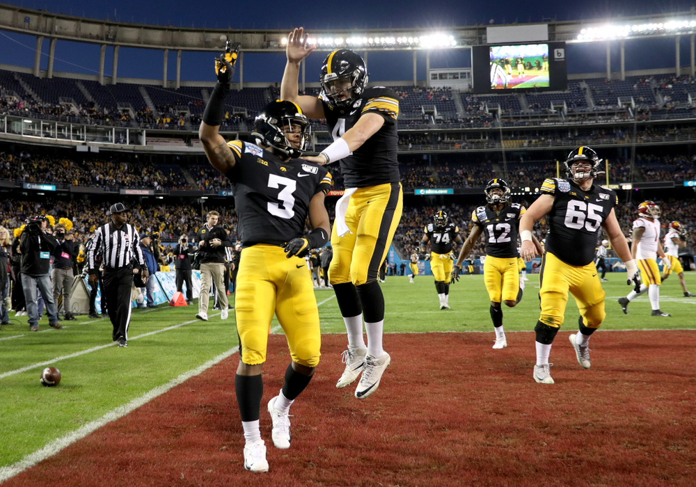 Iowa Hawkeyes wide receiver Tyrone Tracy Jr. (3) and quarterback Nate Stanley (4) celebrate after scoring against USC in the Holiday Bowl Friday, December 27, 2019 at San Diego Community Credit Union Stadium. (Brian Ray/hawkeyesports.com)