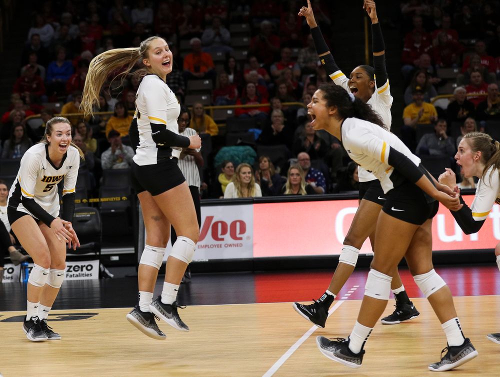 Iowa Hawkeyes outside hitter Meghan Buzzerio (5), Iowa Hawkeyes defensive specialist Maddie Slagle (15), Iowa Hawkeyes setter Brie Orr (7) and Iowa Hawkeyes outside hitter Taylor Louis (16) celebrate after winning a point during a match against Nebraska at Carver-Hawkeye Arena on November 7, 2018. (Tork Mason/hawkeyesports.com)