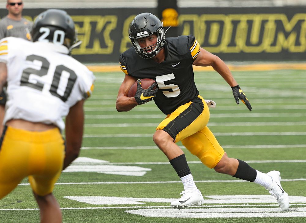 Iowa Hawkeyes wide receiver Oliver Martin (5) runs after pulling in a pass during Fall Camp Practice No. 8 at Kids Day at Kinnick Stadium in Iowa City on Saturday, Aug 10, 2019. (Stephen Mally/hawkeyesports.com)