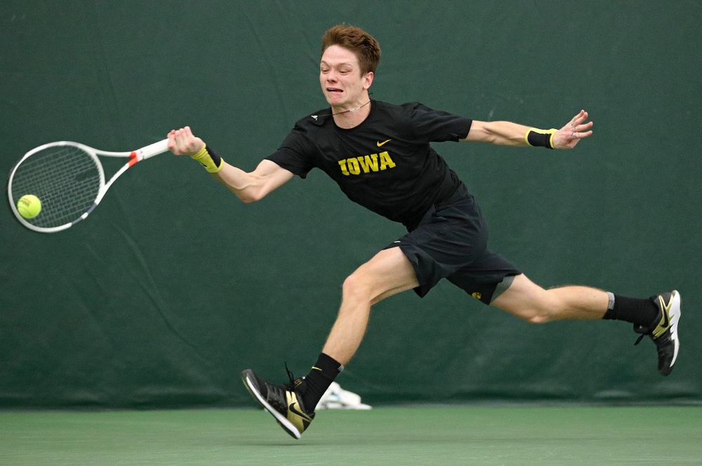Iowa’s Jason Kerst hits a shot during his match against Marquette at the Hawkeye Tennis and Recreation Complex in Iowa City on Saturday, January 25, 2020. (Stephen Mally/hawkeyesports.com)