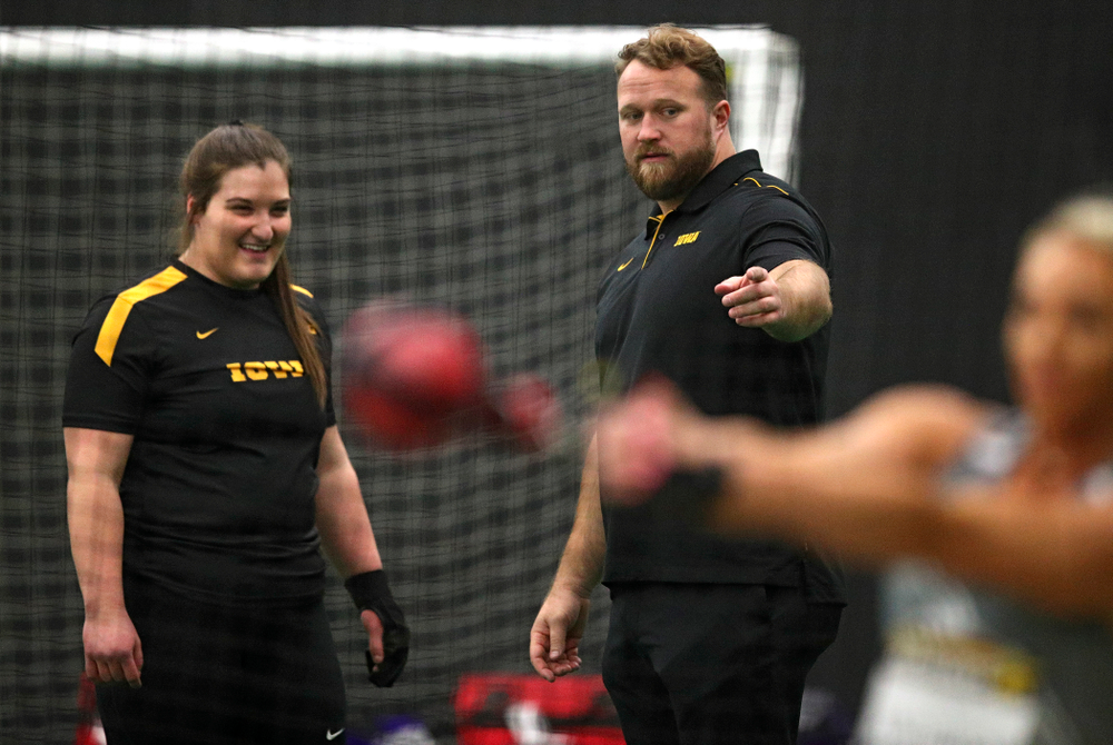 Iowa’s Jamie Kofron (from left) talks with assistant coach Eric Werskey during the women’s weight throw event during the Hawkeye Invitational at the Hawkeye Tennis and Recreation Complex in Iowa City on Friday, January 10, 2020. (Stephen Mally/hawkeyesports.com)