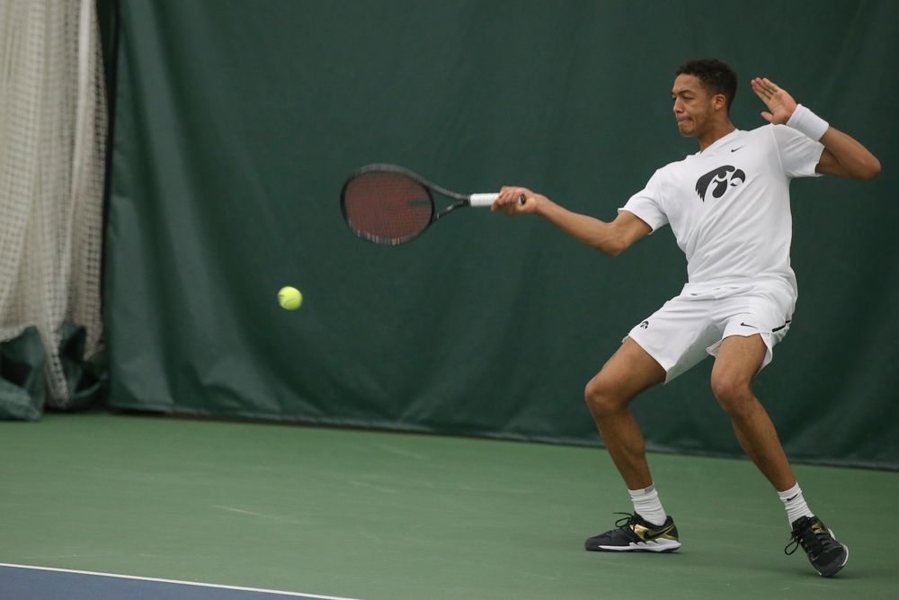 Iowa’s Oliver Okonkwo returns a hit during the Iowa men’s tennis meet vs Nebraska on Sunday, March 1, 2020 at the Hawkeye Tennis and Recreation Complex. (Lily Smith/hawkeyesports.com)