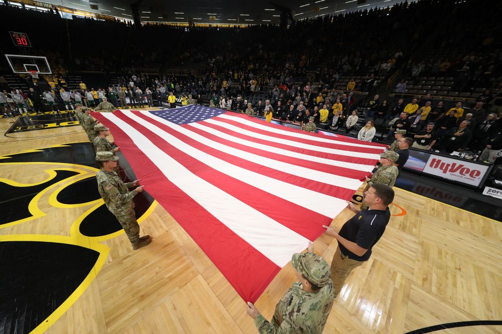 Service members stretch out a large American flag before the Iowa Hawkeyes game against UW Green Bay Sunday, November 11, 2018 at Carver-Hawkeye Arena. (Brian Ray/hawkeyesports.com)