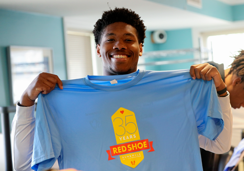 Iowa football players help fold shirts at the Ronald McDonald House for their Red Shoe Run/Walk during the 21st annual ISAAC Hawkeye Day of Caring in Iowa City on Sunday, Apr. 28, 2019. (Stephen Mally/hawkeyesports.com)