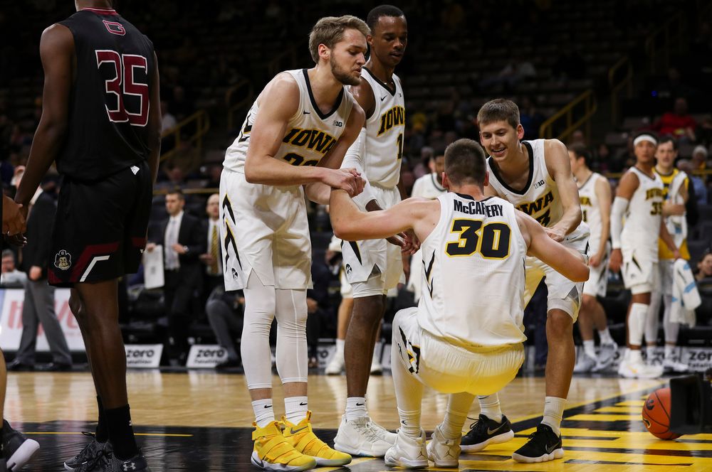 Iowa Hawkeyes forward Riley Till (20) and Iowa Hawkeyes guard Austin Ash (13) pick up Iowa Hawkeyes guard Connor McCaffery (30) after McCaffery was fouled during a game against Guilford College at Carver-Hawkeye Arena on November 4, 2018. (Tork Mason/hawkeyesports.com)