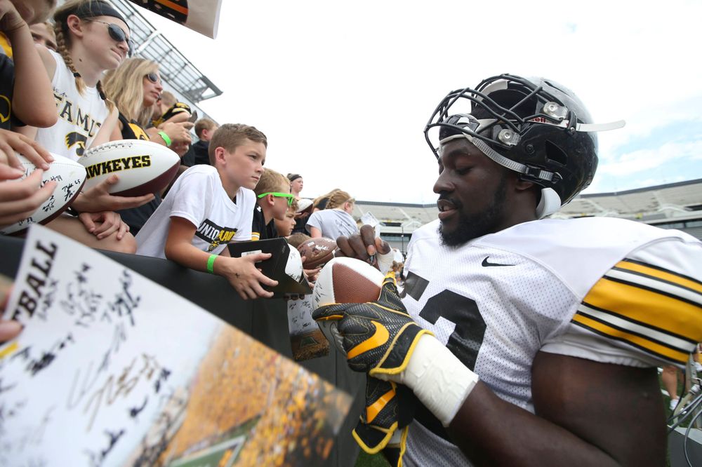 Iowa Hawkeyes linebacker Amani Jones (52) signs autographs during Kids Day at Kinnick Stadium on Saturday, August 10, 2019. (Lily Smith/hawkeyesports.com)