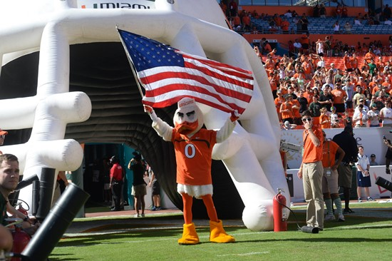Sebastian the Ibis leads the University of Miami Hurricanes through a tunnel of smoke in a game against the Georgia Tech Yellow Jackets at Sun Life...