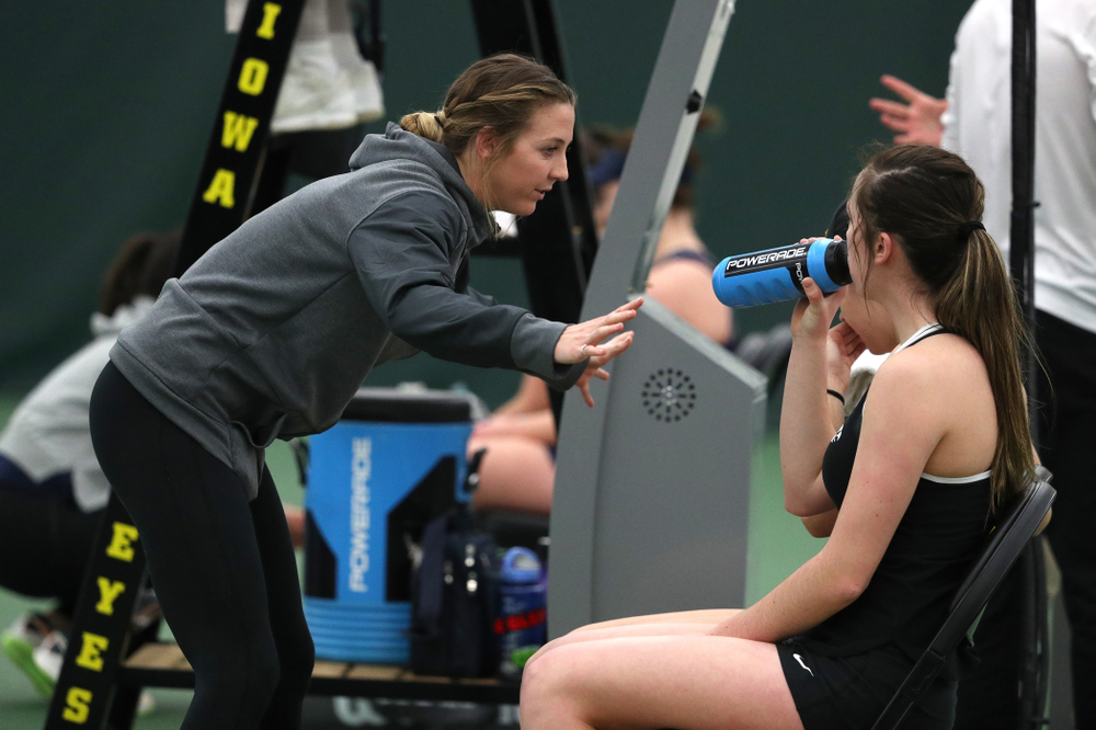 Volunteer assistant coach Cassidy Spearman talks with Samantha Mannix and Elise Van Heuvelen Treadwell as they play a doubles match against the Penn State Nittany Lions Sunday, February 24, 2019 at the Hawkeye Tennis and Recreation Complex. (Brian Ray/hawkeyesports.com)