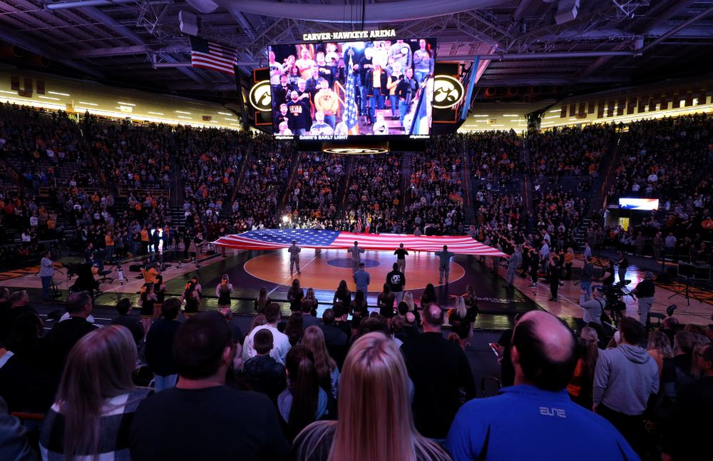 Members of the military spread out a large flag during the National Anthem before the Iowa Hawkeyes meet against Minnesota Saturday, February 15, 2020 at Carver-Hawkeye Arena. (Brian Ray/hawkeyesports.com)
