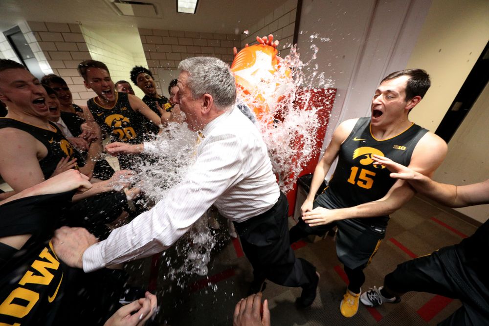 Iowa Hawkeyes assistant coach Kirk Speraw has a bucket of water dumped on him as the Iowa Hawkeyes celebrate their win against the Iowa State Cyclones Thursday, December 12, 2019 at Hilton Coliseum in Ames, Iowa(Brian Ray/hawkeyesports.com)