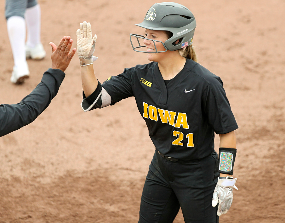 Iowa outfielder Havyn Monteer (21) gets a high-five after a bunt single during the fifth inning of their game against Iowa Softball vs Indian Hills Community College at Pearl Field in Iowa City on Sunday, Oct 6, 2019. (Stephen Mally/hawkeyesports.com)