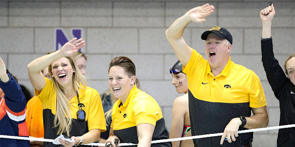 Iowa assistant coach Emma Sougstad (from left), assistant coach/women’s recruiting coordinator Sarah Stockwell-Gregson, and assistant coach/men’s recruiting coordinator Brian Schrader urge on Lauren McDougall (not pictured) as she swims the women’s 500 yard freestyle preliminary event during the 2020 Women’s Big Ten Swimming and Diving Championships at the Campus Recreation and Wellness Center in Iowa City on Thursday, February 20, 2020. (Stephen Mally/hawkeyesports.com)