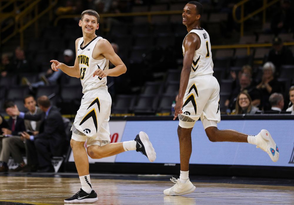 Iowa Hawkeyes guard Austin Ash (13) reacts after making a 3-pointer during a game against Guilford College at Carver-Hawkeye Arena on November 4, 2018. (Tork Mason/hawkeyesports.com)
