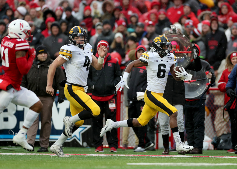 Iowa Hawkeyes quarterback Nate Stanley (4) blocks for wide receiver Ihmir Smith-Marsette (6) on his way to a touchdown against the Nebraska Cornhuskers Friday, November 29, 2019 at Memorial Stadium in Lincoln, Neb. (Brian Ray/hawkeyesports.com)