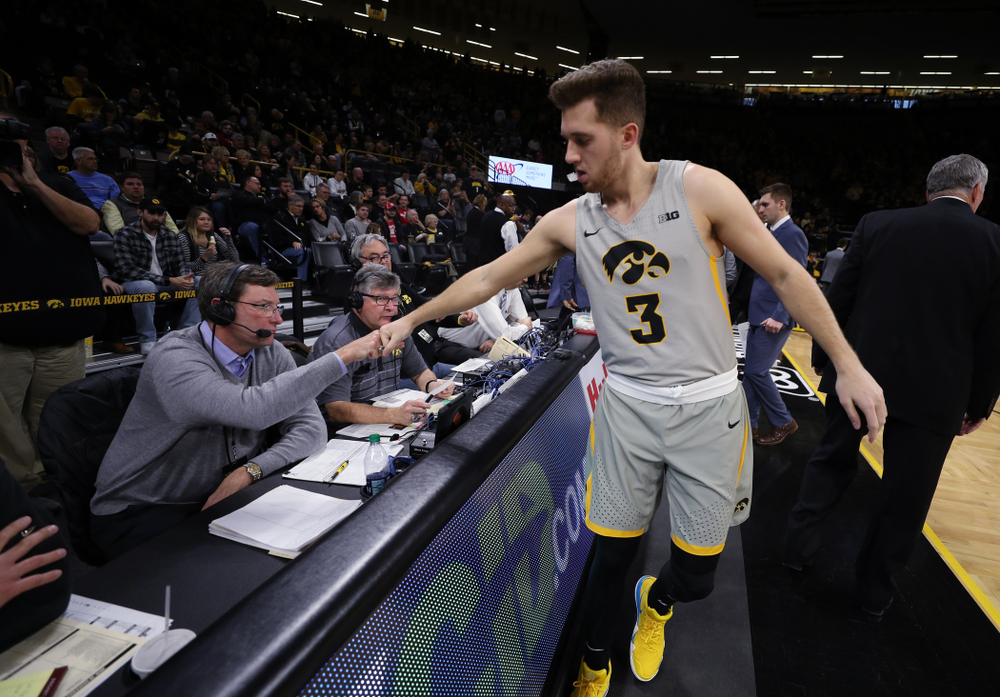 Iowa Hawkeyes guard Jordan Bohannon (3) fist bumps radio announcer Bobby Hansen before their game against the Nebraska Cornhuskers Sunday, January 6, 2019 at Carver-Hawkeye Arena. (Brian Ray/hawkeyesports.com)