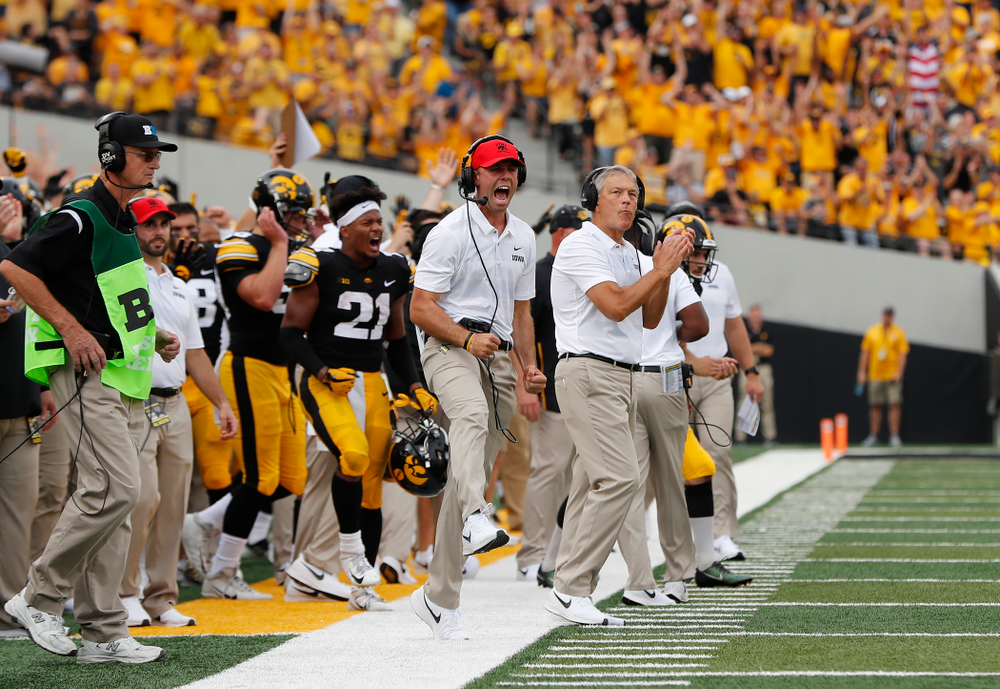 Iowa Hawkeyes head coach Kirk Ferentz and offensive student assistant Declan Doyle celebrate a touchdown against the Northern Illinois Huskies Saturday, September 1, 2018 at Kinnick Stadium. (Brian Ray/hawkeyesports.com)