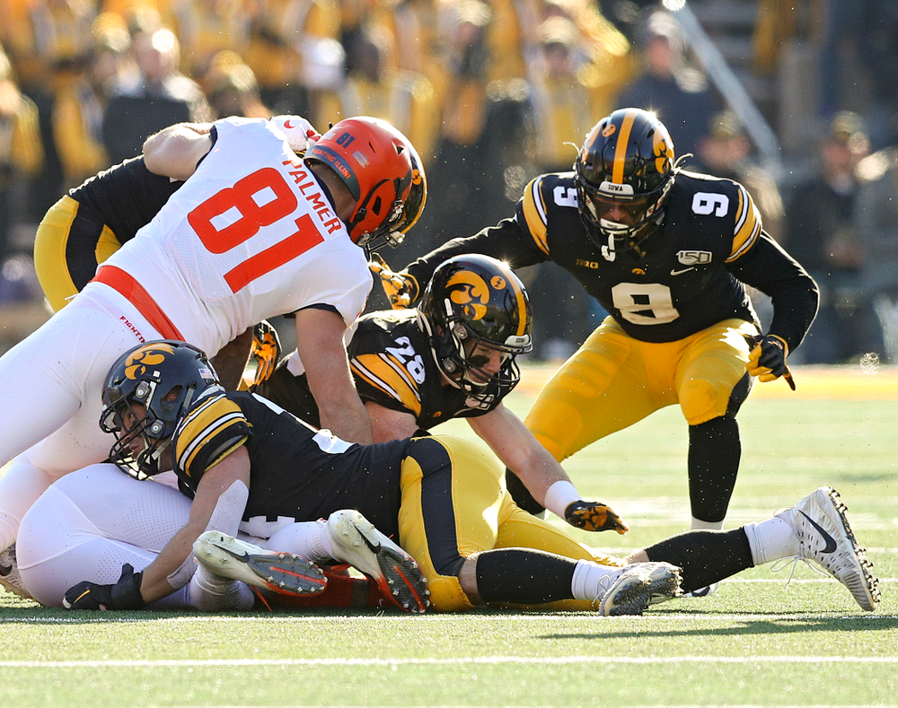 Iowa Hawkeyes defensive back Jack Koerner (28) recovers a fumble by Illinois Fighting Illini quarterback Brandon Peters (18) after it was forced out by linebacker Kristian Welch (34) as defensive back Geno Stone (9) closes in during the fourth quarter of their game at Kinnick Stadium in Iowa City on Saturday, Nov 23, 2019. (Stephen Mally/hawkeyesports.com)