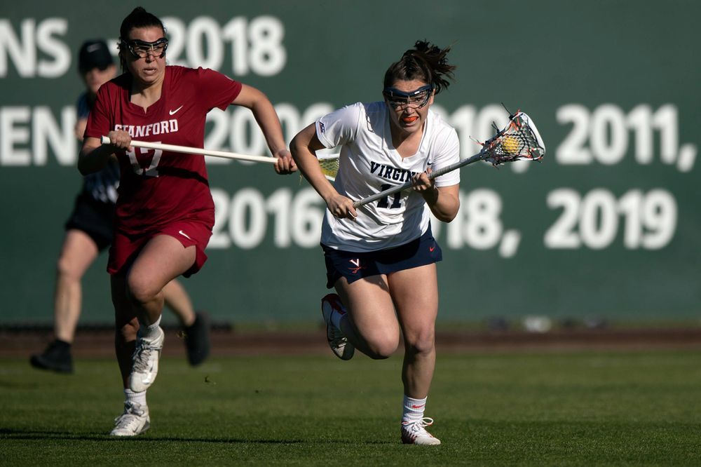 STANFORD, California - FEBRUARY 14: Virginia Cavaliers midfield Halle Graham (11) runs up field past Stanford Cardinal attack Katherine Gjertsen (17) during the first half at Cagan Stadium on February 14, 2020 in Stanford, California. The Virginia Cavaliers defeated the Stanford Cardinal 12-11. (Photo by Jason O. Watson)