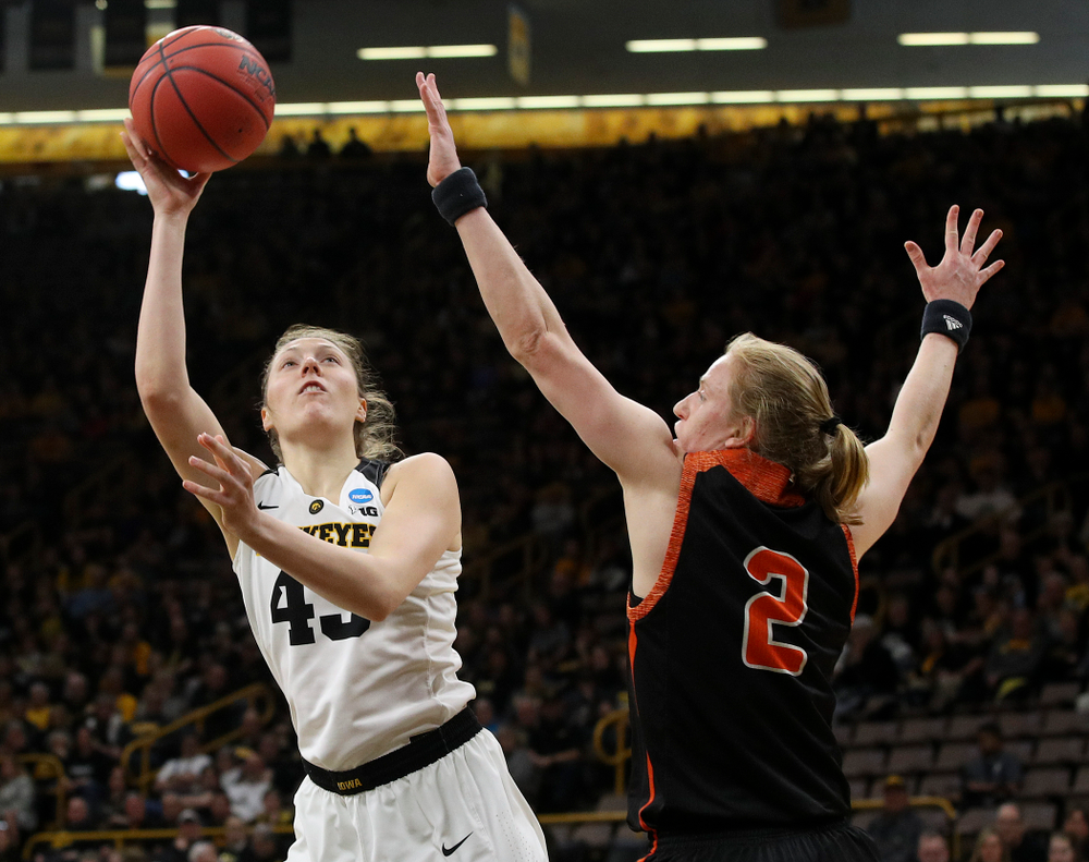 Iowa Hawkeyes forward Amanda Ollinger (43) shoots around Mercer Bears forward Amanda Thompson (2) during the first round of the 2019 NCAA Women's Basketball Tournament at Carver Hawkeye Arena in Iowa City on Friday, Mar. 22, 2019. (Stephen Mally for hawkeyesports.com)