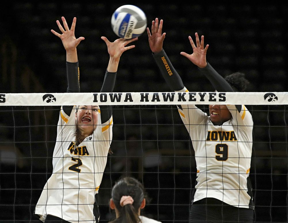 Iowa’s Courtney Buzzerio (2) gets her hand on the ball as Amiya Jones (9) tries for the block during their Big Ten/Pac-12 Challenge match at Carver-Hawkeye Arena in Iowa City on Saturday, Sep 7, 2019. (Stephen Mally/hawkeyesports.com)