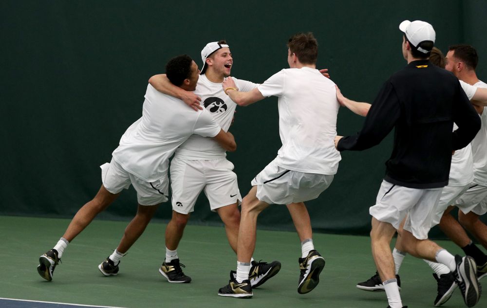 Iowa’s Will Davies celebrates with his teammates after defeating Cornell’s Lev Kazakov in three sets to clench at 4-3 victory Sunday, March 8, 2020 at the Hawkeye Tennis and Recreation Center. (Brian Ray/hawkeyesports.com)
