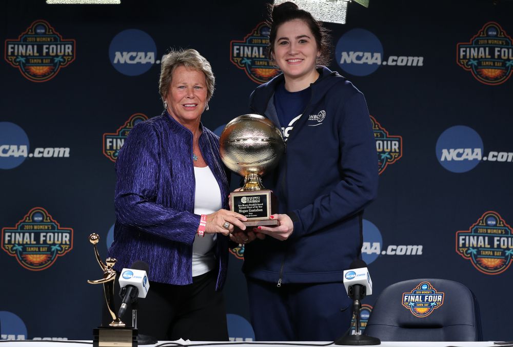 Iowa Hawkeyes forward Megan Gustafson (10) receives US Basketball Writers Association Ann Meyers Drysdale Player of the Year award from Ann Meyers Drysdale during a news conference Friday, April 5, 2019 at Amalie Arena in Tampa, FL. (Brian Ray/hawkeyesports.com)