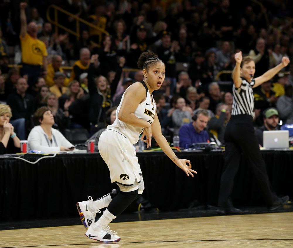Iowa Hawkeyes guard Tania Davis (11) plays the "air guitar" as she celebrates after making a 3-pointer during the fourth quarter of their second round game in the 2019 NCAA Women's Basketball Tournament at Carver Hawkeye Arena in Iowa City on Sunday, Mar. 24, 2019. (Stephen Mally for hawkeyesports.com)