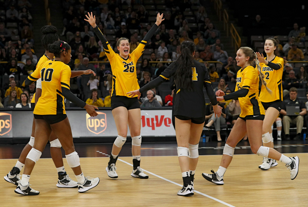 Iowa’s Amiya Jones (9), Griere Hughes (10), Edina Schmidt (20), Halle Johnston (4), Maddie Slagle (15), and Courtney Buzzerio (2) celebrate a score during the first set of their match at Carver-Hawkeye Arena in Iowa City on Friday, Nov 29, 2019. (Stephen Mally/hawkeyesports.com)