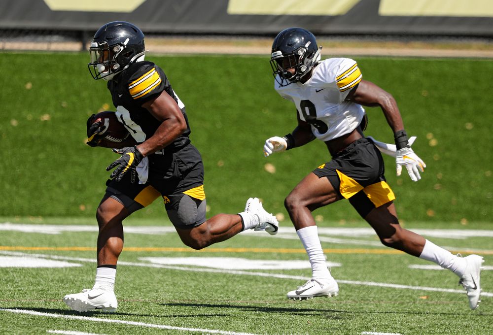 Iowa Hawkeyes running back Mekhi Sargent (10) runs down field as defensive back Matt Hankins (8) gives chase during Fall Camp Practice No. 7 at the Hansen Football Performance Center in Iowa City on Friday, Aug 9, 2019. (Stephen Mally/hawkeyesports.com)