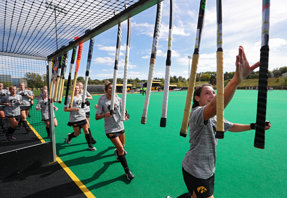 The Iowa Hawkeyes grab their sticks before the start of their match at Grant Field in Iowa City on Friday, Oct 4, 2019. (Stephen Mally/hawkeyesports.com)