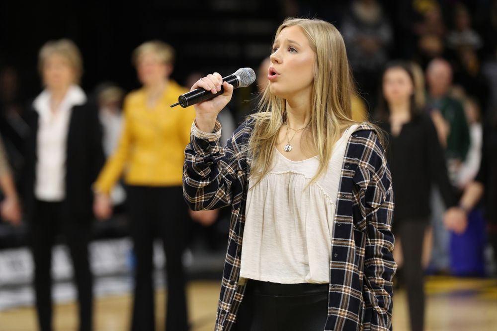 Iowa Hawkeyes head coach Lisa Bluder watches as her daughter Emma sings the National Anthem before the Iowa Hawkeyes game against the Northwestern Wildcats Sunday, March 3, 2019 at Carver-Hawkeye Arena. (Brian Ray/hawkeyesports.com)