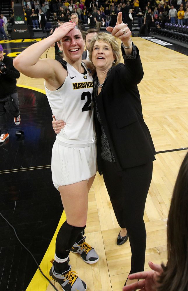 Iowa Hawkeyes forward Hannah Stewart (21) and head coach Lisa Bluder look up at the video board after winning their second round game in the 2019 NCAA Women's Basketball Tournament at Carver Hawkeye Arena in Iowa City on Sunday, Mar. 24, 2019. (Stephen Mally for hawkeyesports.com)